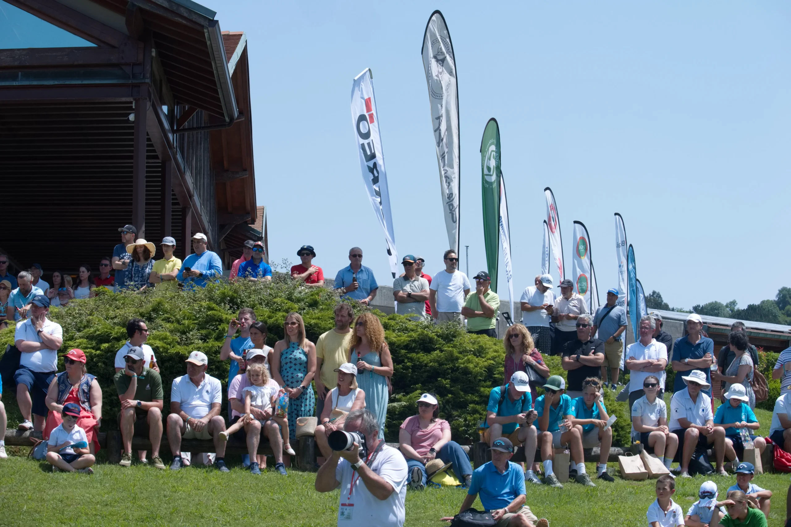 Fans follow the prize-giving ceremony beside the Meaztegi clubhouse at the Bizkaia PGAe Open